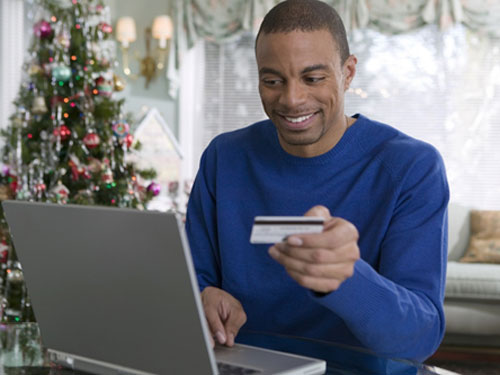 man with a gift card shopping online
